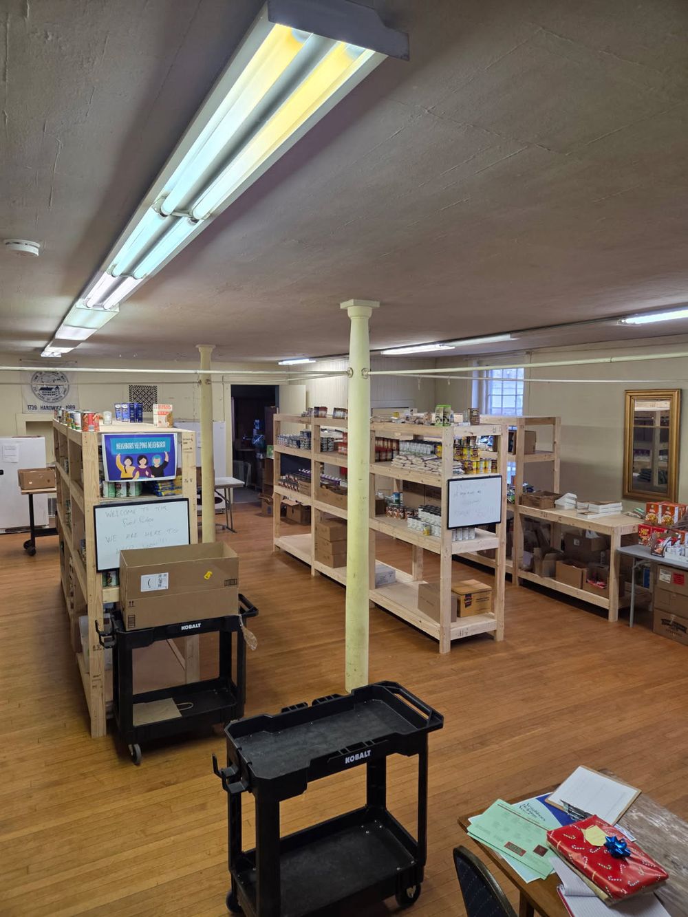 Inside the Hardwick Food Pantry: wooden shelves stocked with canned and boxed food